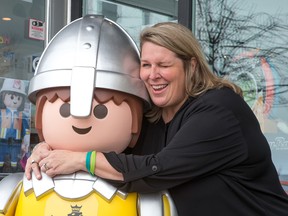 Patti Taggart, owner of Tag Along Toys in Kanata, with her new large size Playmobil Knight donated to her store by the manufacturer after her original was stolen from the store front last week.