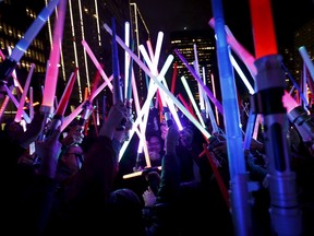People gather with their lightsabers during a Star Wars themed lightsaber battle at Sue Bierman Park in San Francisco, California December 18, 2015. REUTERS/Stephen Lam
