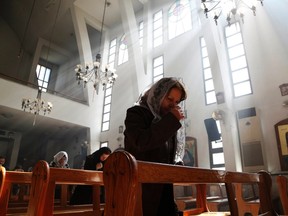 An Assyrian woman attends a mass in solidarity with the Assyrians abducted by Islamic State fighters in Syria earlier this week, inside Ibrahim al-Khalil church in Jaramana, eastern damascus March 1, 2015. Militants in northeast Syria are now estimated to have abducted at least 220 Assyrian Christians this week, a group monitoring the war reported. REUTERS/Omar Sanadiki (SYRIA - Tags: POLITICS CIVIL UNREST CONFLICT RELIGION TPX IMAGES OF THE DAY)