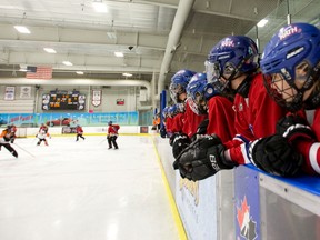 Players from the Calgary Rath watch the play during their over-21 ringette game at the Western Fair Sports Cente in London, Ont. on Thursday April 7, 2016. 
They were participating in the Canadian ringette championships being played this week in London. (Mike Hensen/The London Free Press/Postmedia Network)