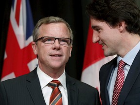 Prime Minister Justin Trudeau (R) greets Saskatchewan Premier Brad Wall during the First Ministers' meeting in Ottawa on November 23, 2015. REUTERS/Chris Wattie