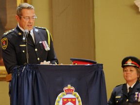 Chief Gilles Larochelle recognizes Deputy Chief Antje McNeely for her 30 years of service at the Kingston Police Awards Ceremony at City Hall in Kingston, Ont. on Thursday April 7, 2016. Steph Crosier/Kingston Whig-Standard/Postmedia Network