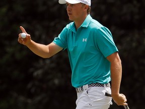 Jordan Spieth holds up his ball after putting on the 11th green during the first round of the Masters in Augusta, Ga., on Thursday, April 7, 2016. (Charlie Riedel/AP Photo)