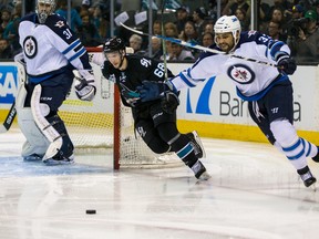 Winnipeg Jets defenseman Dustin Byfuglien (33) and San Jose Sharks right wing Melker Karlsson (68) vie for possession during the second period at SAP Center at San Jose. 
Mandatory Credit: John Hefti-USA TODAY Sports