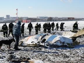 In this March 20, 2016 file photo, Russian Emergency Ministry employees investigate the wreckage of a crashed plane at the Rostov-on-Don airport, south of Moscow, Russia. (AP Photo, File)