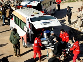 In this file photo released on Dec. 28, 2015, by the Syrian official news agency SANA, Syrian Red Crescent workers carry a wounded Syrian opposition fighter, during an evacuation from the town of Zabadani, in Syria. A surgeon was killed by a sniper in the besieged town in western Syria this past month in a stark reminder that sieges continue to kill Syrians despite international efforts to defuse them in halting negotiations in Europe. (SANA via AP, File)