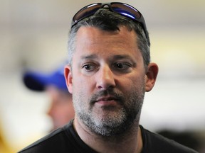 Tony Stewart hangs out in the garage during practice for the NASCAR Sprint Cup Series auto race at Texas Motor Speedway in Fort Worth, Texas, on April 7, 2016. (AP Photo/Ralph Lauer)
