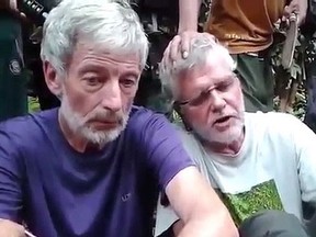 Robert Hall (l) and John Ridsdel are seen in this still image taken from an undated militant video. Canadians Hall and Ridsdel, a Norwegian man and a Filipina woman were taken hostage by gunmen from the Holiday Ocean View Samal Resort on Samal Island in the Philippines in September. THE CANADIAN PRESS/HO via Youtube