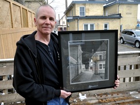 Artist Marshall Custus, a former Unity Project participant, displays his charcoal on canvas drawing of the Unity Project’s building on Dundas Street in London Ont. April 8, 2016. Custus’ work, created during his time with the local shelter, will be part of the Unity Project’s annual UPwithART fundraiser.  CHRIS MONTANINI\LONDONER\POSTMEDIA NETWORK