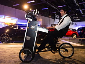 Jason Kodie entertains with his portable piano during the 2015 Edmonton Motorshow Precious Metal Gala at the Edmonton Expo Centre in Edmonton, Alta., on Wednesday, April 8, 2015. Codie McLachlan/Edmonton Sun/QMI Agency