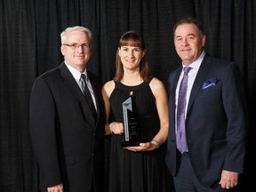 Rick Lystang, left, with his wife Krista Lystang and award sponsor Bob Moon receiving the award for best single family bungalow under $450,000 at the 2016 Awards of Excellence in Housing on March 19.  - Photo supplied