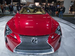 Media crowds around the newly unveiled Lexus LC 500 at the Edmonton EXPO Centre at Northlands in Edmonton, Alta on Wednesday, April 6, 2016. (Photo by Ryan Wellicome)