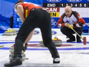 Canada's skip Kevin Koe (right) calls a shot during the Page 1-2 playoff game against Denmark at the World Men's Curling Championship in Basel, Switzerland, on Friday, April 8, 2016. (Georgios Kefalas/Keystone via AP)