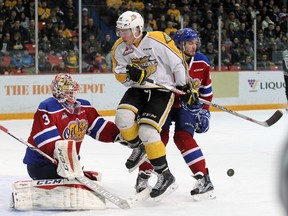 Tanner Kaspick #16 of the Brandon Wheat Kings leaps to avoid a shot on net while blocking goalie Payton Lee #30 of the Edmonton Oil Kings during game six of their WHL playoff series at Westman Place in Brandon on Tuesday evening.