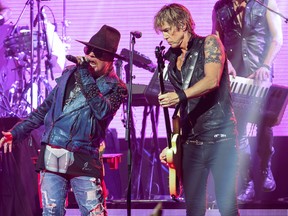 In this April 23, 2014 file photo, Axl Rose, left, and Duff McKagan of Guns N' Roses perform at the 6th Annual Revolver Golden Gods Award Show in Los Angeles. (Photo by Paul A. Hebert/Invision/AP, File)