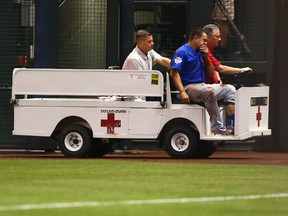 Chicago Cubs outfielder Kyle Schwarber sits in a cart as he is taken off the field after suffering an injury in an outfield collision against the Arizona Diamondbacks at Chase Field. (Mark J. Rebilas/USA TODAY Sports)