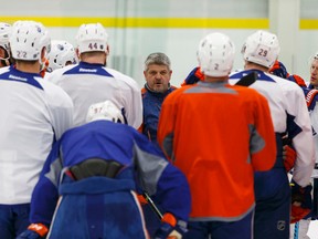 Edmonton's head coach Todd McLellan speaks with players during an Edmonton Oilers practice at Leduc Recreation Centre in Leduc, Alta., on Friday April 8, 2016.