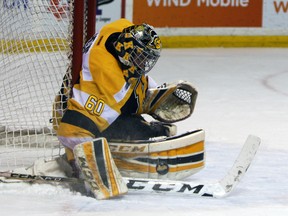 Kingston Frontenacs goalie Jeremy Helvig covers up a shot from Niagara IceDogs' Stephen Harpe during the first period of their Ontario Hockey League Eastern Conference semifinal series against the Niagara IceDogs at the Rogers K-Rock Centre in Kingston on Friday. (Steph Crosier/The Whig-Standard)