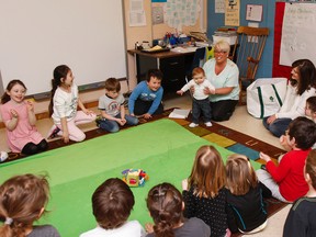 Holy Name Catholic School kindergarten students spend some quality time with Baby Noah and his mother during the family's monthly visit with students as part of the Roots of Empathy program. (Julia McKay/The Whig-Standard)