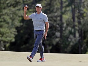 Rory McIlroy holds up his ball after putting out on the 18th hole during the second round of the Masters in Augusta, Ga., on Friday, April 8, 2016. (Chris Carlson/AP Photo)