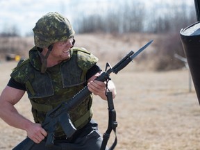 Canadian bobsledder Derek Plug runs the bayonet course at the Canadian Forces Base in Wainright, Alta on Thursday, April 7, 2016. The athletes are part of an exchange with the Canadian Armed Forces in which they participate in each other's training. (Photo by Ryan Wellicome)