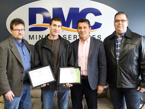 Al Herbert, a superintendent at DMC Mining Services (second from left) receives a pair of awards from Darren Tschanz, vice-president of Canadian operations at DMC (left), John LeClair, vice-president of safety and environmental, and Jason Bridge, president of Northern Medical Supply, after saving an infant from choking at a Keg Steakhouse in Burlington, Ont. two weeks ago. Ben Leeson/The Sudbury Star/Postmedia Network