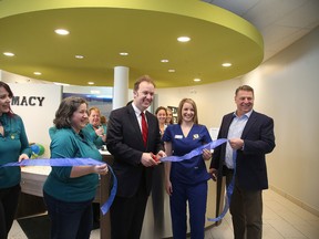 Sudbury MP Paul Lefebvre helps cut the ribbon with pharmacist Delia Brereton and MedviewMD CEO Dan Nead at the grand opening of MedviewMD in Sudbury, Ont. on Thursday April 7, 2016. Gino Donato/Sudbury Star/Postmedia Network