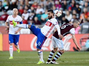 Toronto FC forward Mo Babouli (11) and Colorado Rapids midfielder Sam Cronin (6) battle for control of the ball in the first half of the match at Dicks Sporting Goods Park. Ron Chenoy-USA TODAY Sports