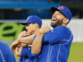 Jose Bautista stretches as the Toronto Blue Jays warm-up in advance of their home opener against the Boston Red Sox at the Rogers Centre in Toronto, Ont. on Friday April 8, 2016. Stan Behal/Toronto Sun/Postmedia Network