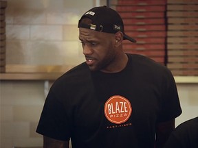 LeBron James worked alongside Blaze Pizza employees, carrying pizza boxes and taking orders, on March 11. (YouTube screengrab)