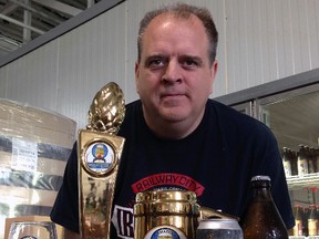 Paul Corriveau of Railway City Brewing Company displays the gold trophy The Witty Traveller brought home from the Canadian Brewing Awards in 2015.