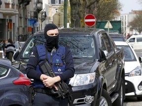 Belgium police officers secure the access during a police operation in Etterbeek, near Brussels, Belgium, on April 9, 2016. (REUTERS/Yves Herman)