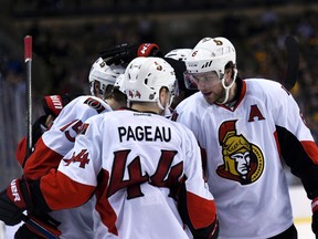 Senators centre Zack Smith (15) is congratulated by Jean-Gabriel Pageau (44) and Bobby Ryan (6) after scoring a goal against the Bruins at TD Garden in Boston on Saturday, April, 9, 2016. (Bob DeChiara/USA TODAY Sports)