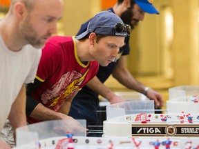 Thomas Hunter (centre) takes part in the Alberta Stiga Table Hockey Championships at West Edmonton Mall on Jan. 30. (Photo by David Bloom)