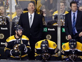 Boston Bruins head coach Claude Julien stands behind the team's bench during third-period NHL action against the Ottawa Senators at TD Garden in Boston on April 9, 2016. (AP Photo/Elise Amendola)