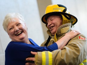 Janice Elliott and Ed Bigelow share a laugh as Ed dressed up as a fire fighter at their wedding Saturday.