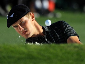 Bryson DeChambeau chips out of a bunker on the 18th hole during the third round of the Masters golf tournament in Augusta, Ga., on April 9, 2016. (AP Photo/Jae C. Hong)