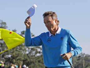 Bernhard Langer tips his cap after putting out on the 18th hole during the third round of the Masters golf tournament in Augusta, Ga., on April 9, 2016. (AP Photo/Jae C. Hong)