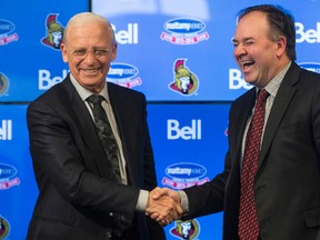 Former Ottawa Senators' General Manager, Bryan Murray, left, shakes hands with the new GM, Pierre Dorion, at a press conference where he announced he's stepping down as general manager of the team but staying on as senior hockey advisor at the Canadian Tire Centre Sunday, April 10, 2016. (Darren Brown/Postmedia Network)