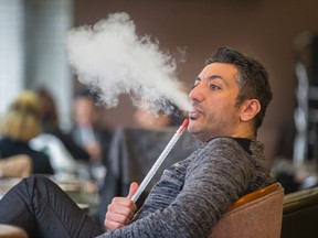 Mohamad Zahwi, owner of ShiShawarma, poses for a photo with a shisha pipe filled with double apple herbal essence (no tobacco) in Toronto April 7, 2016. (Ernest Doroszuk/Toronto Sun)