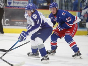 Sudbury Wolves Alan Lyszczarczyk skates past Kitchener Rangers Nick Magyar during OHL action from the Sudbury Community Arena in Sudbury, Ont. on Friday October 2, 2015. Lyszczarczyk is coming off a strong showing with Team Poland at IIHF U18 championships. Gino Donato/Sudbury Star/Postmedia Network