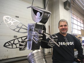 Tec Voc welding instructor Tony Bage sits next to one of his student's pieces in Winnipeg, Man. Wednesday April 6, 2016. (Brian Donogh/Winnipeg Sun/Postmedia Network)