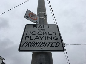 A city sign citing the ban on ball and hockey playing in streets. (Don Peat/Toronto Sun)