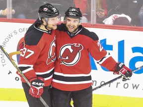 New Jersey Devils centre Pavel Zacha, left, and right winger Kyle Palmieri celebrate a goal by Palmieri against the Toronto Maple Leafs during the third period at the Prudential Center Saturday night. Zacha, a Sarnia Sting forward, made his NHL debut and picked up two assists. (Ed Mulholland-USA TODAY Sports)