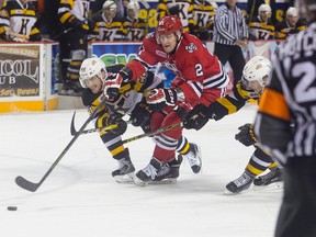 Pavel Jenys of the Niagara IceDogs battles Roland McKeown, left, and Nathan Billitier of the Kingston Frontenacs for the puck during OHL playoff action at the Meridian Centre in St. Catharines on Sunday.
(Julie Jocsak/Postmedia Network)