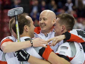 Canada's skip Kevin Koe, center facing, celebrates winning the gold medal game against Denmark with teammates at the world men's curling championship 2016 in the St. Jakobshalle in Basel, Switzerland, on Sunday April 10, 2016. (Georgios Kefalas/Keystone via AP)