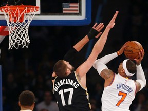 Raptors' Jonas Valanciunas defends against Knicks' Carmelo Anthony on Sunday night at Madison Square Garden in New York. (AP/PHOTO)