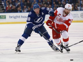 Tampa Bay Lightning left wing Ondrej Palat and Detroit Red Wings left wing Henrik Zetterberg fight to control the puck during the first period at Amalie Arena. (Kim Klement-USA TODAY Sports)