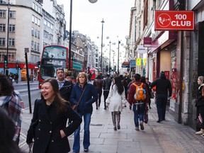 In this Jan 10, 2016 photo, shoppers and tourists walk past the 100 Club on Oxford Street in London. The Sex Pistols played here in May 1976 and the venue hosted a punk festival in the fall of ’76. In January 2016, ‘70s bands including 999, The Members, UK Subs and Discharge played here as part of a punk series. (Jonathan Elderfield via AP)