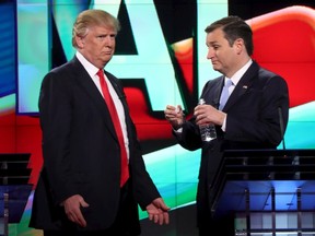 Donald Trump and Ted Cruz talk during a commercial break during a Republican debate. (Reuters files)